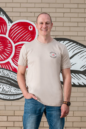 Tan Cherry Blend T Shirt with logo on the upper chest.