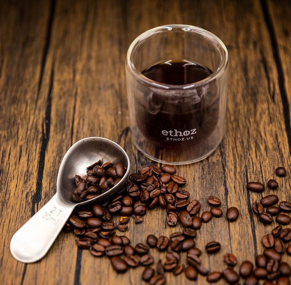 Ethoz glass cup full of coffee beans 